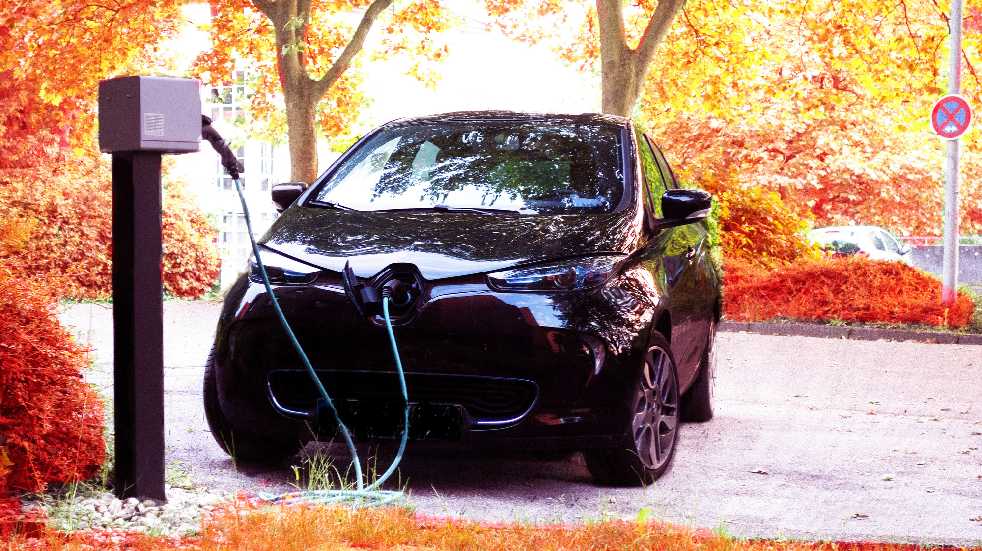 electric car charging in autumn
